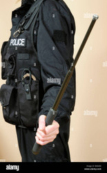 Police Officer holding an expandable baton.